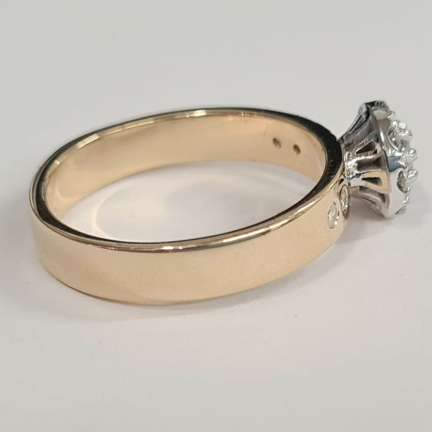 18ct halo cluster ring, the halo of diamonds is set in white gold, the halo is set onto a 4mm yellow gold band which has 4 bullet set diamonds in it