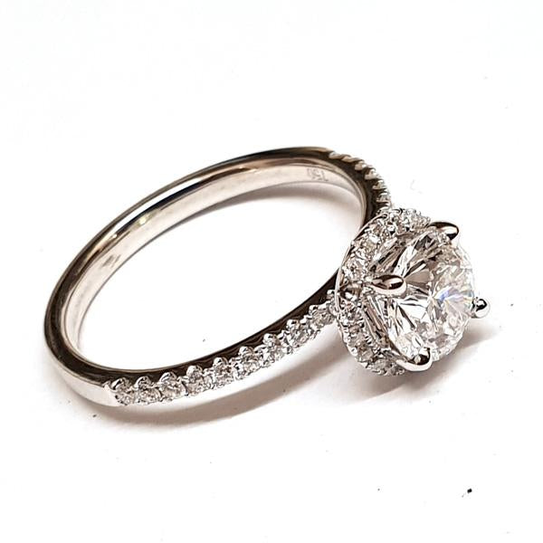 18ct white gold diamond halo solitaire engagement ring, the ring has a round brilliant cut diamond at the centre