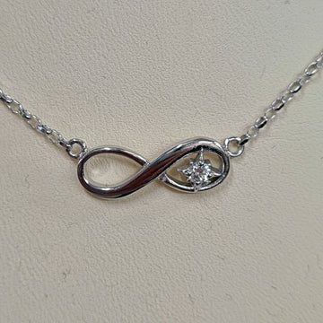 white gold infinity bracelet with a birthstone set in the middle of one of the loops