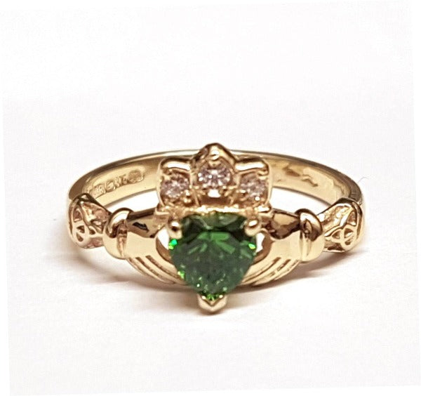 9ct yellow gold ladies birthstone claddagh ring with heart shaped stone in the centre and small round stones in the crown with green stone in the centre