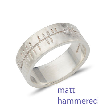sterling silver flat band wit a matt hammered finish and inscribed with celtic Ogham