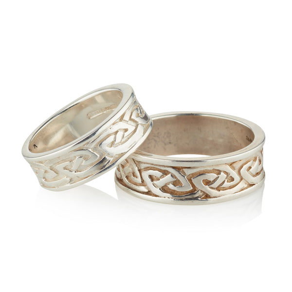 white gold matching his and her wide celtic wedding ring set.  the 2 celtic rings are solid and have plain straight rimms on each side