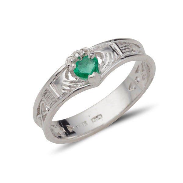 white gold wishbone shaped claddadg ring with a small heart shaped emerald set into claws