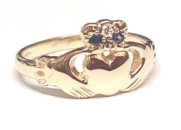 yellow gold claddagh ring with small sapphires and diamond set into the crown