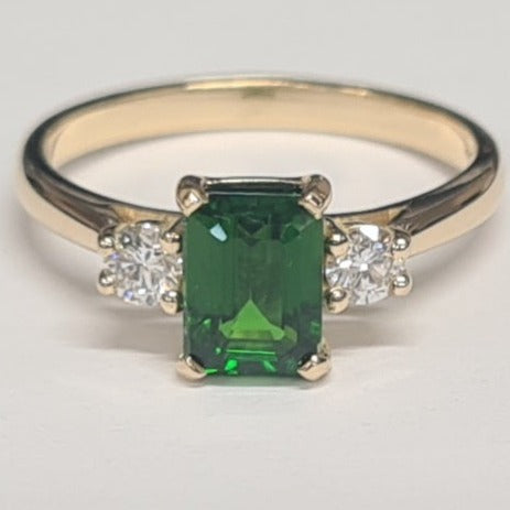 18ct yellow gold 3 stone ring.   the ring has an emerald cut green tourmaline and lab created diamond all set in yellow gold