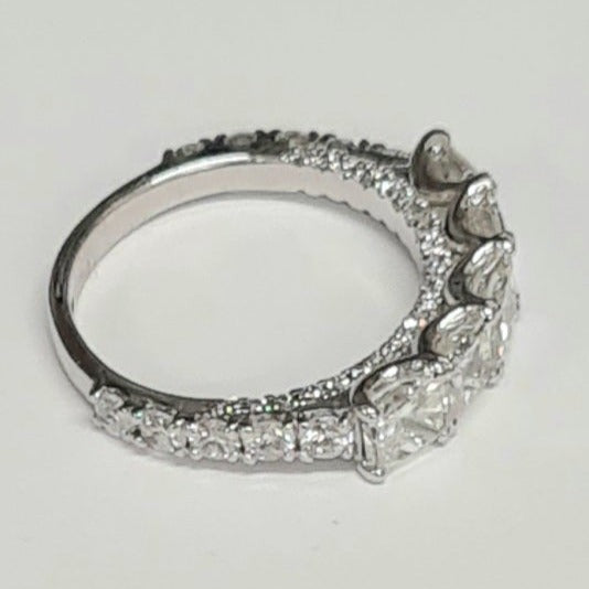 platinum-five-stone-princess-cut-diamond-ring-all the diamonds-are-claw-set-the-ring-has-round-graduated-diamonds-set-down-the-shank-and-there-are small-round-brilliant-cut-diamonds-set-on-the-edge-of -the-shank