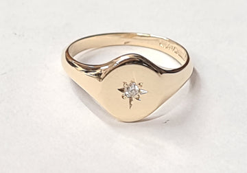 ladies gold signet ring set with a diamond