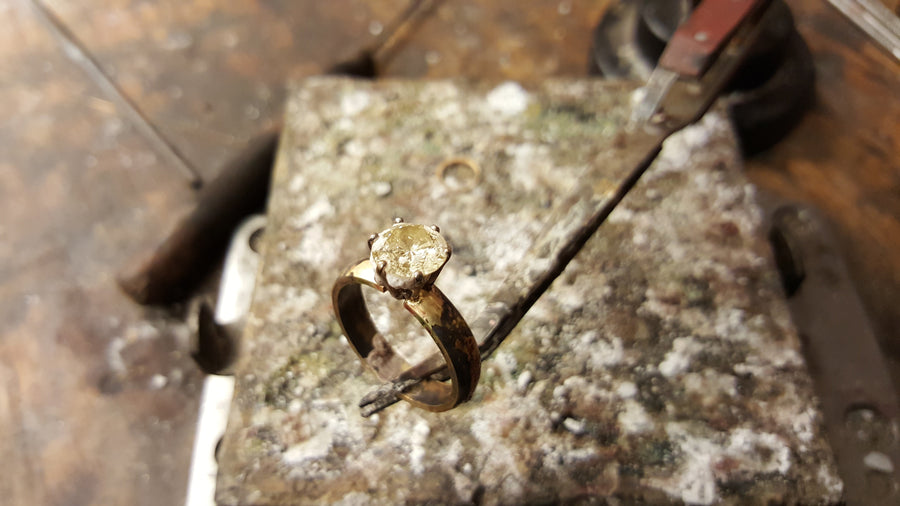 yellow gold ring with a pale yellow stone before it is been set