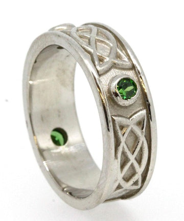 Sterling Silver celtic design ring , it is set with 3 green cubic zirconias, the 3 stones are rubover or bezel set at north east and west points of the ring