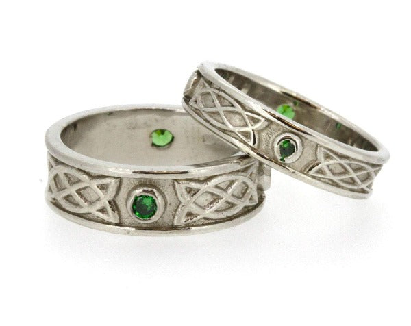 Sterling Silver celtic design matching his and hers rings, they are set with 3 green cubic zirconias in each ring, the 3 stones are rubover or bezel set at north east and west points of the ring,  as shown on a ladies and gents hands
