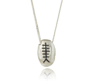 sterling silver pebble with chain going through the pendant,  they are then engraved with an ogham initial