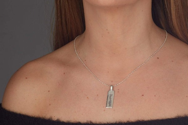 sterling silver personalised ogham pendant and chain this one is 30mm by 10mm as shown on a ladies neck