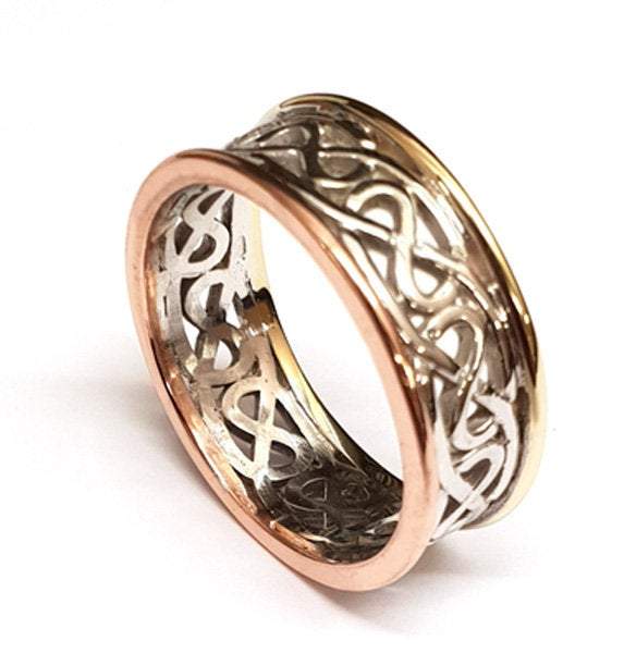 two tone celtic design ring with yellow gold rimms, the centre is silver celtic design pattern that is pierced out, the rimms are slightly raised