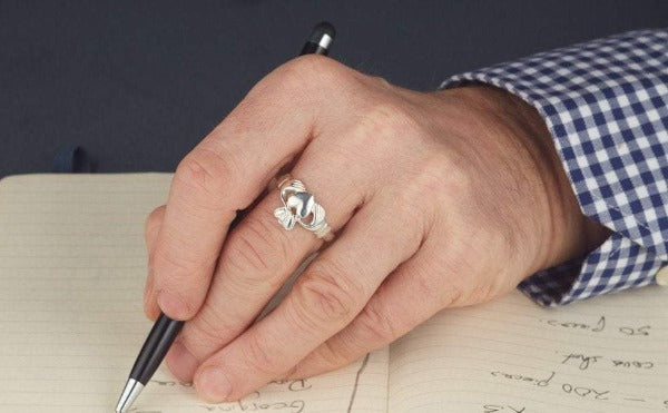 white gold gents classic claddagh ring as shown on a mans hand