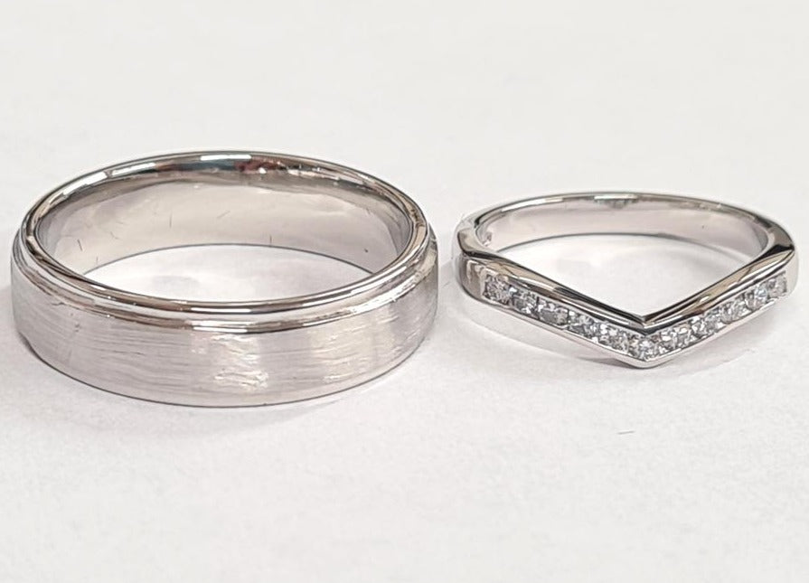 white gold wedding ring set, the gents ring is a step band and the ladies wedding ring is a wishbone ring diamond set
