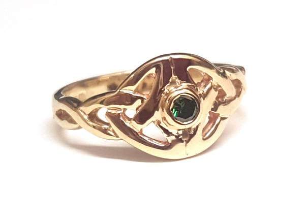 yellow gold Twin celtic trinity triskle knot ring the knots are touching at the widest point and we have set a small round semi precious gemstone in the centre of the ring,  it is bezel set