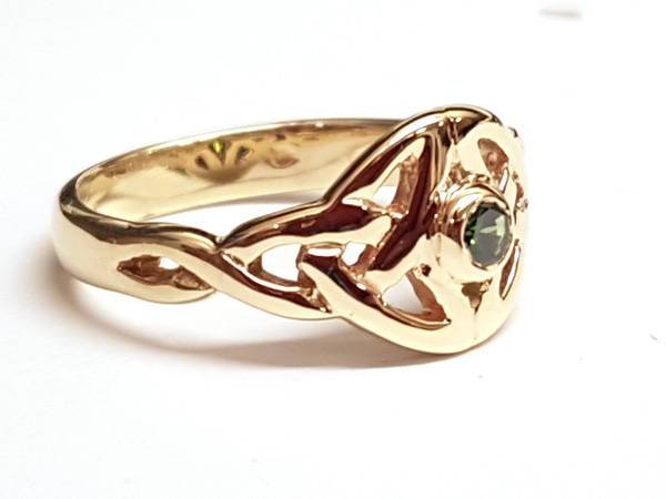 yellow gold Twin celtic trinity triskle knot ring the knots are touching at the widest point and we have set a small round semi precious gemstone in the centre of the ring,  it is bezel set